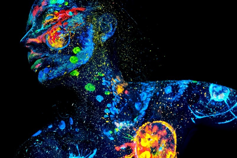 UV painting of a universe on a female body portrait Obraz Człowiek